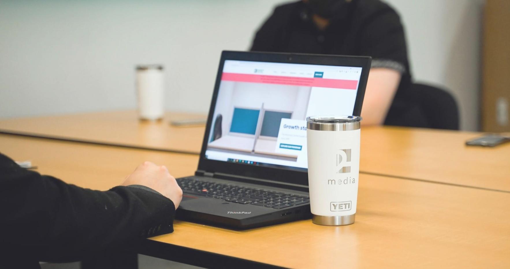 UI/UX design process showing wireframes and prototypes on a designer's desk